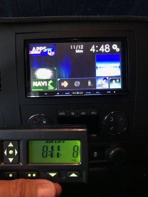 GMC center dash view with active Pioneer 8201 and Air Lift Wireless Air remote.jpg